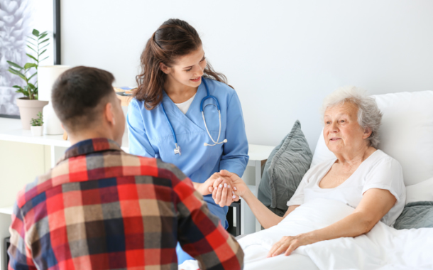 Female nurse visiting senior patient for checking blood pressure