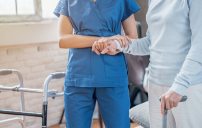 Nurse holding a patients hand and arm