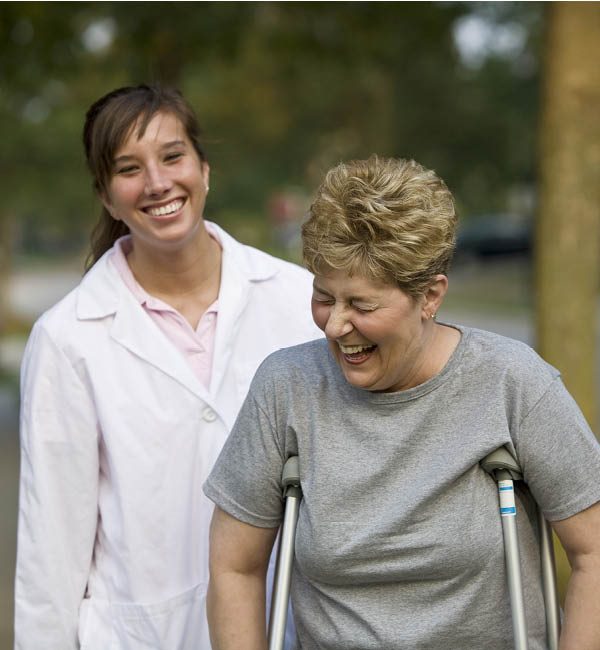 physical therapist helping patient walk