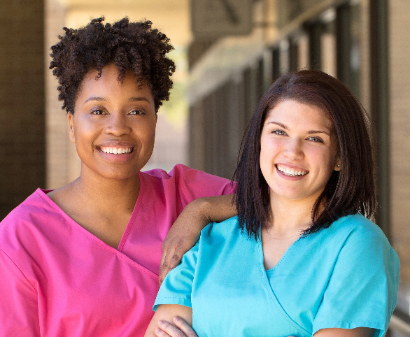 Two female nurses in scrubs