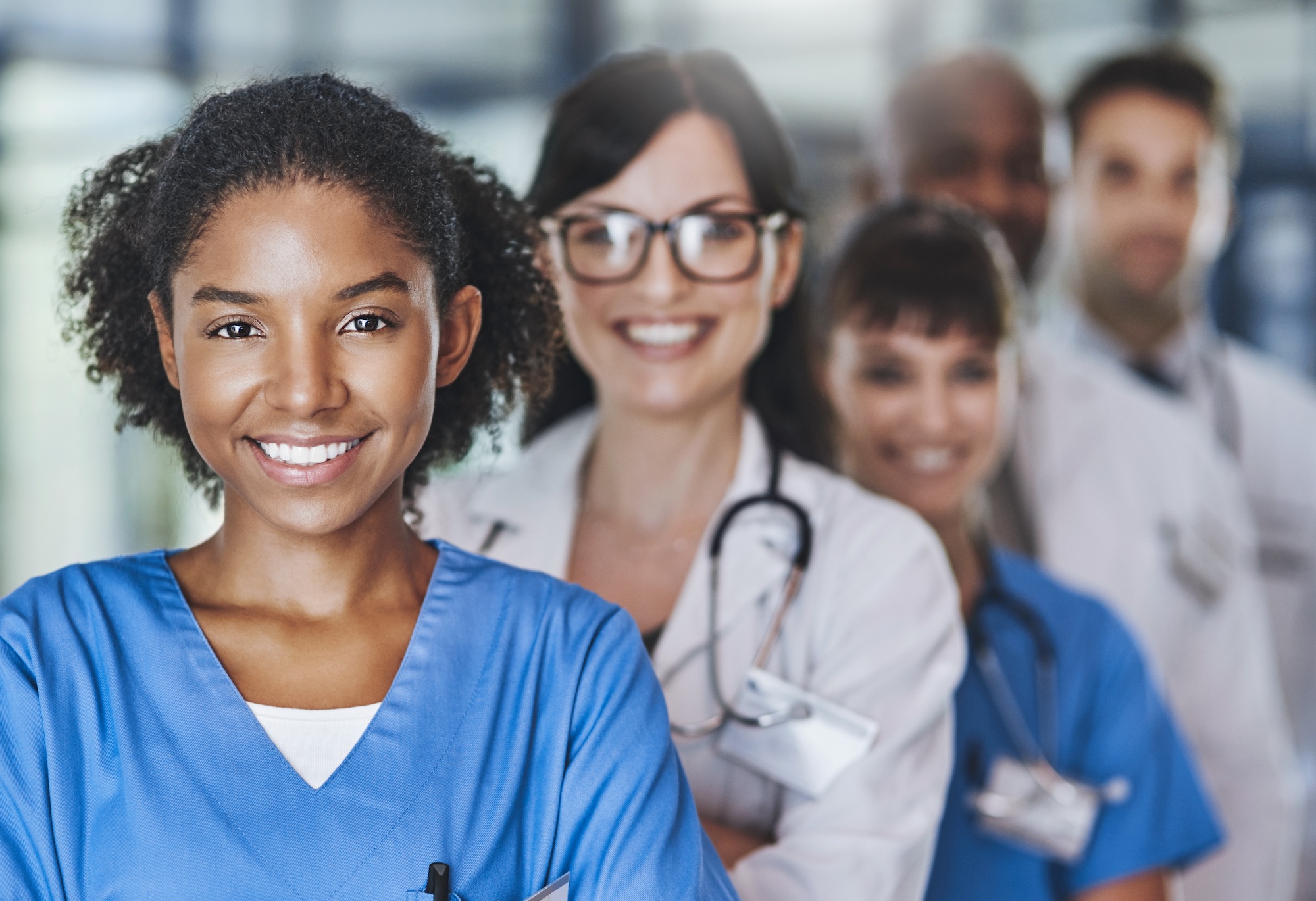 Portrait of a diverse team of caregivers standing together in a hospital.
